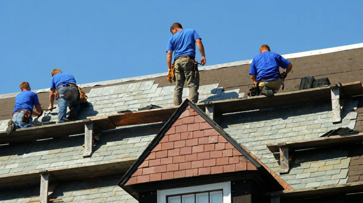 Roof replacement in progress with a team of professional contractors installing new shingles on a residential home in Akron, OH