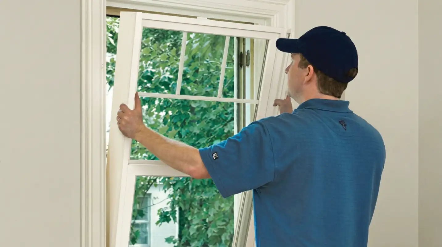 Professional contractors performing a residential window insulation and replacement service in Akron, OH